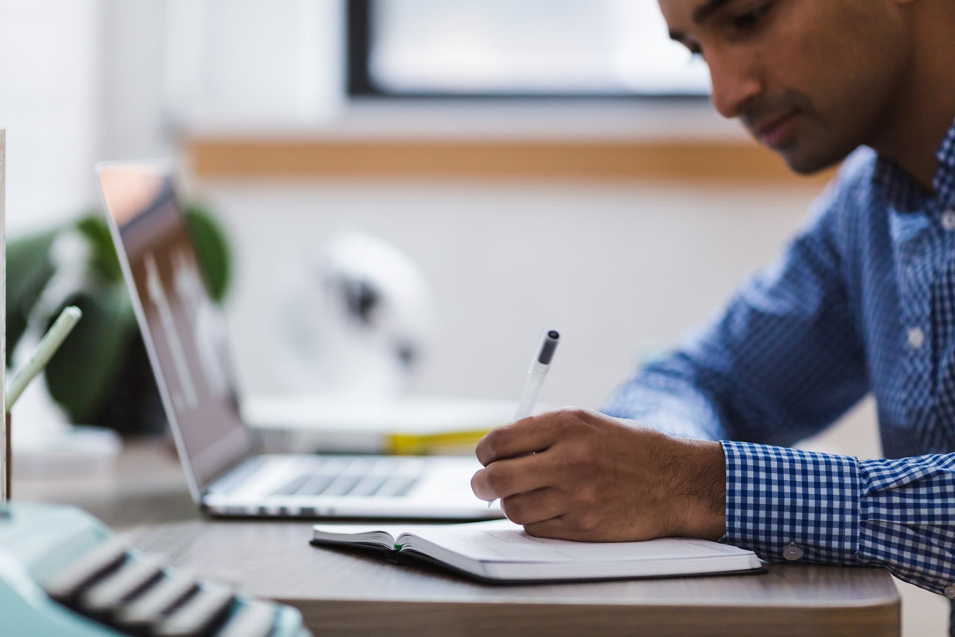 A business owner working through paperwork at a desk